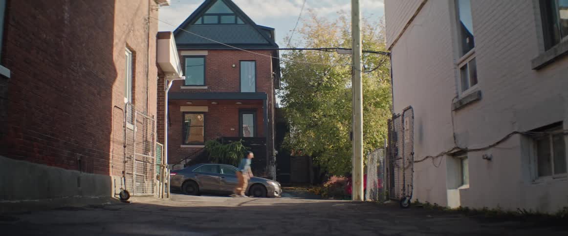 A person skateboards down a neighborhood street
