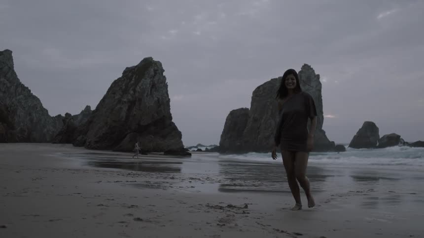Woman slowly jogging on a rocky beach