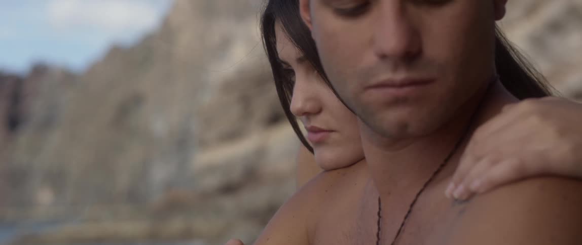 A woman has her head on a man's shoulder
