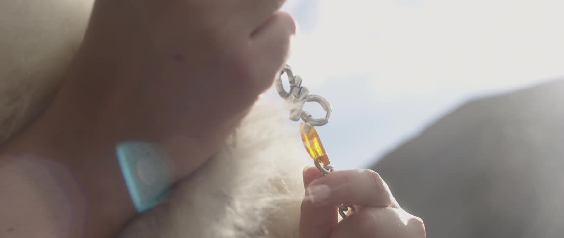 Person holding a piece of jewelry