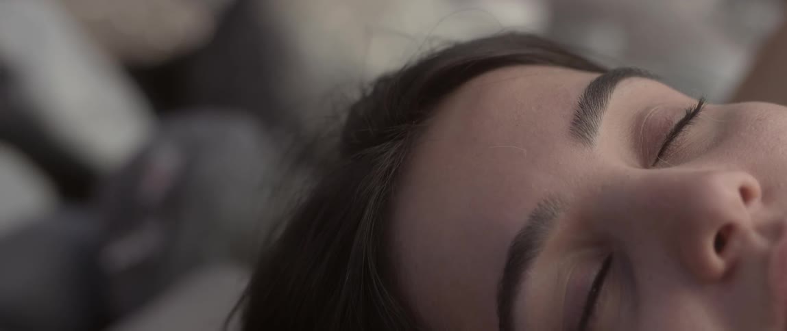 A woman slowly opens her eyes