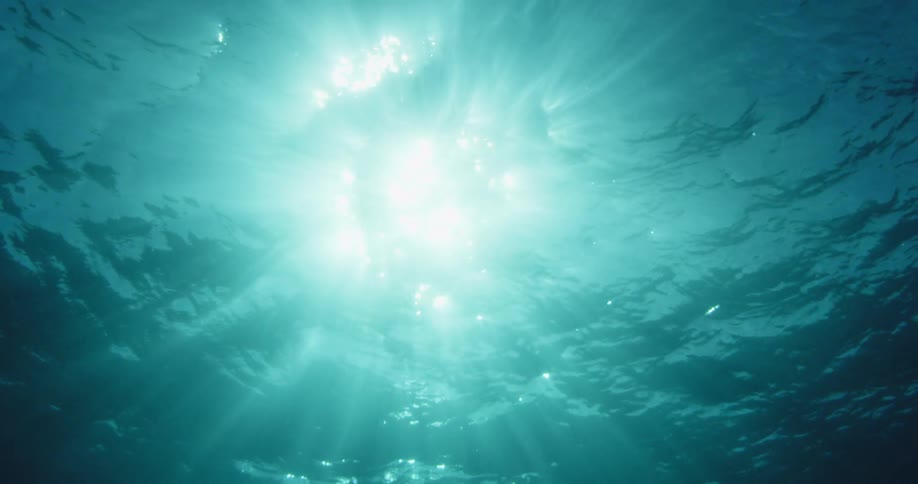 The sun shines over the ocean water