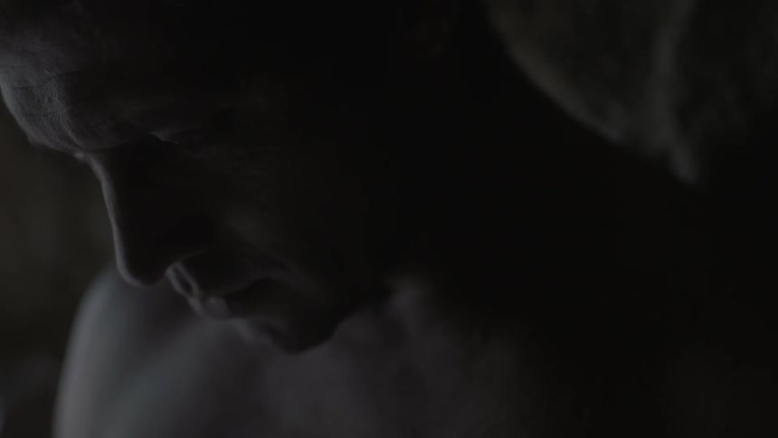 Close-up of a man with his head bowed