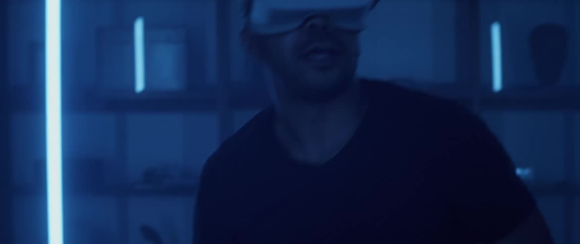 A man is playing a virtual reality game indoors