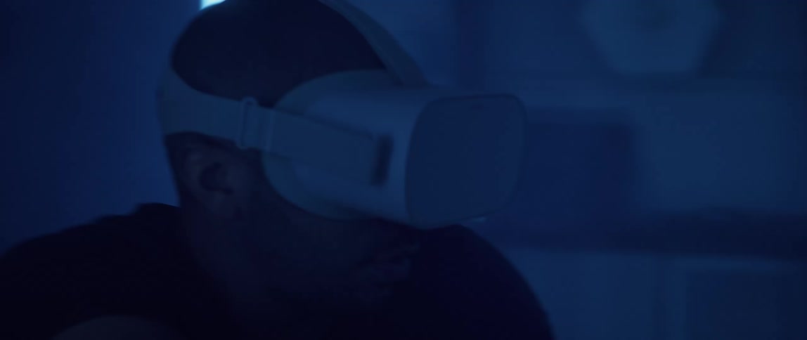 A man makes a shooting motion with his arms while playing virtual reality game