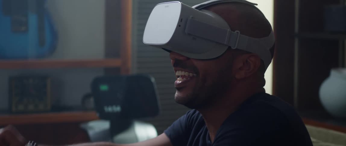 A man is playing a virtual reality game indoors