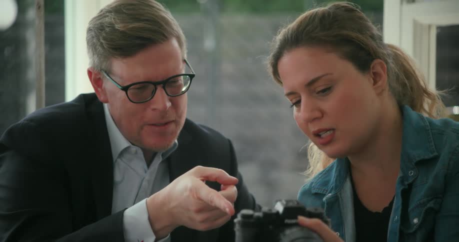 Photographer shows a client the pictures taken on the photoshoot at home