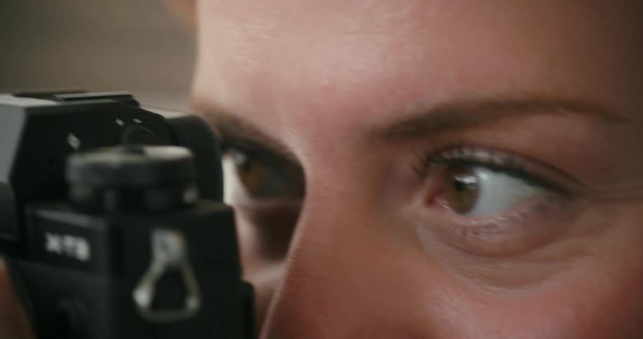 Close up of female photographer taking photos with camera