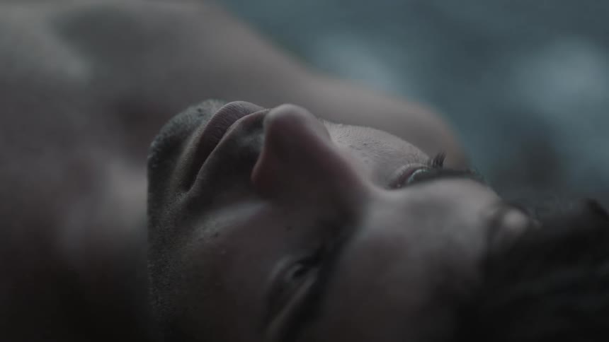 A young man opening his eyes