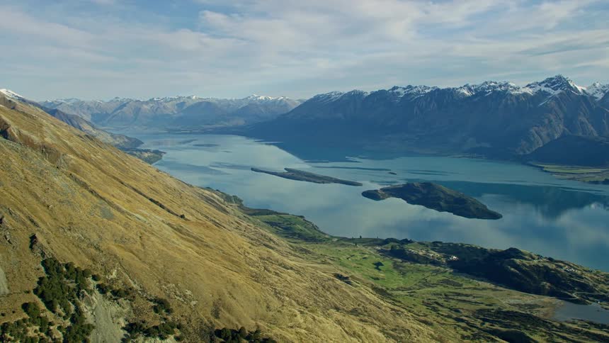 An aerial view of a pristine reflective mountain lake on a winter day