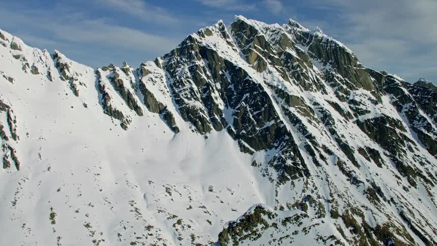 Aerial view of snow covered mountains are displayed