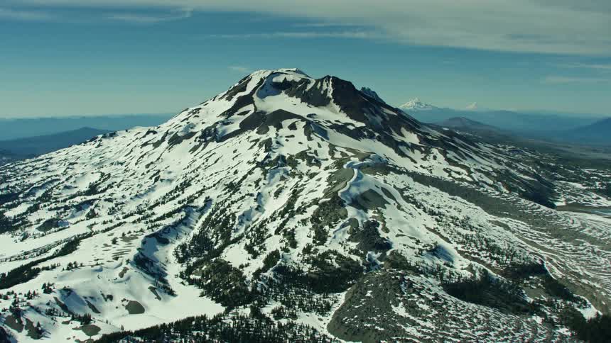 Hyperlapse aerial shot rotating around dormant volcanic South Sister peak in the Cascade Mountains near Bend, Oregon