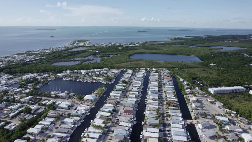 Aerial view of a suburban city is displayed by the coast