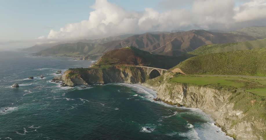An aerial view of ocean waves flowing towards a shoreline