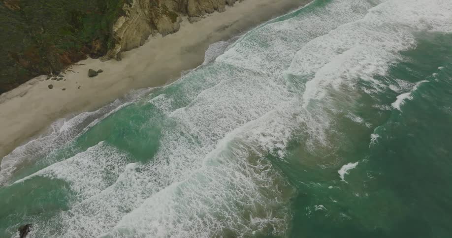 Ocean waves are moving towards the beach coast