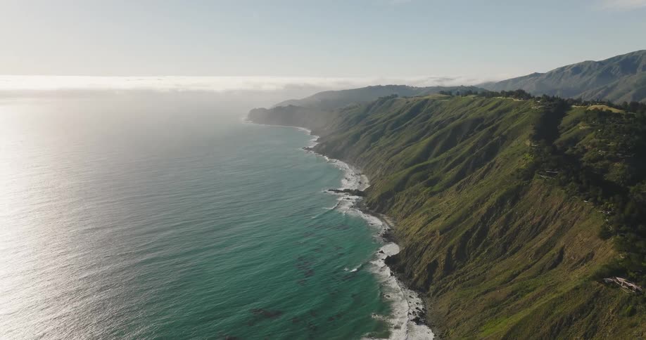 Aerial view of ocean water is displayed at dusk