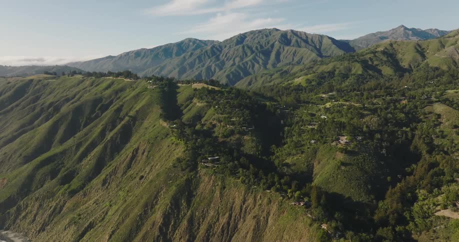 Aerial view of a small town on the slopes of a mountain range at morning