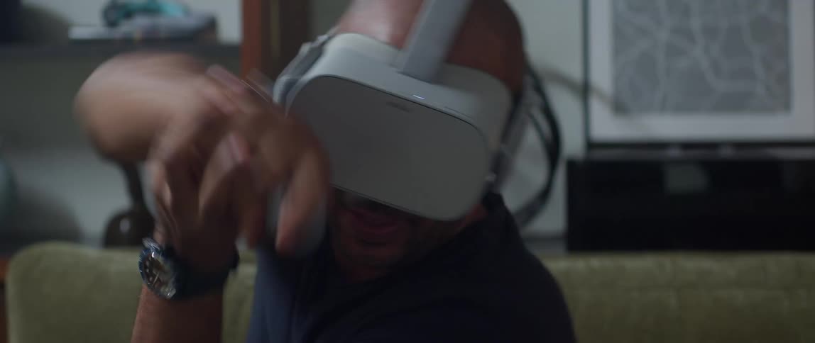 A man in virtual reality headset swing his hands wildly while playing a game