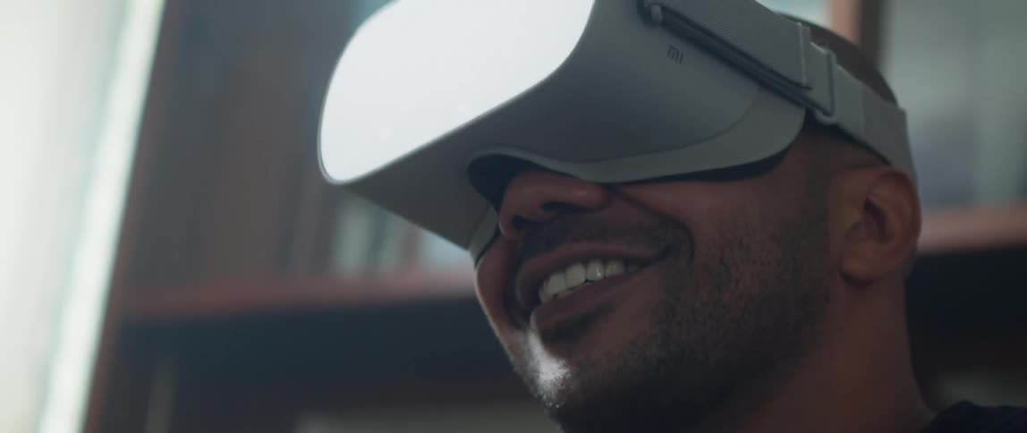 A man smiles after he shoots while playing a virtual reality game