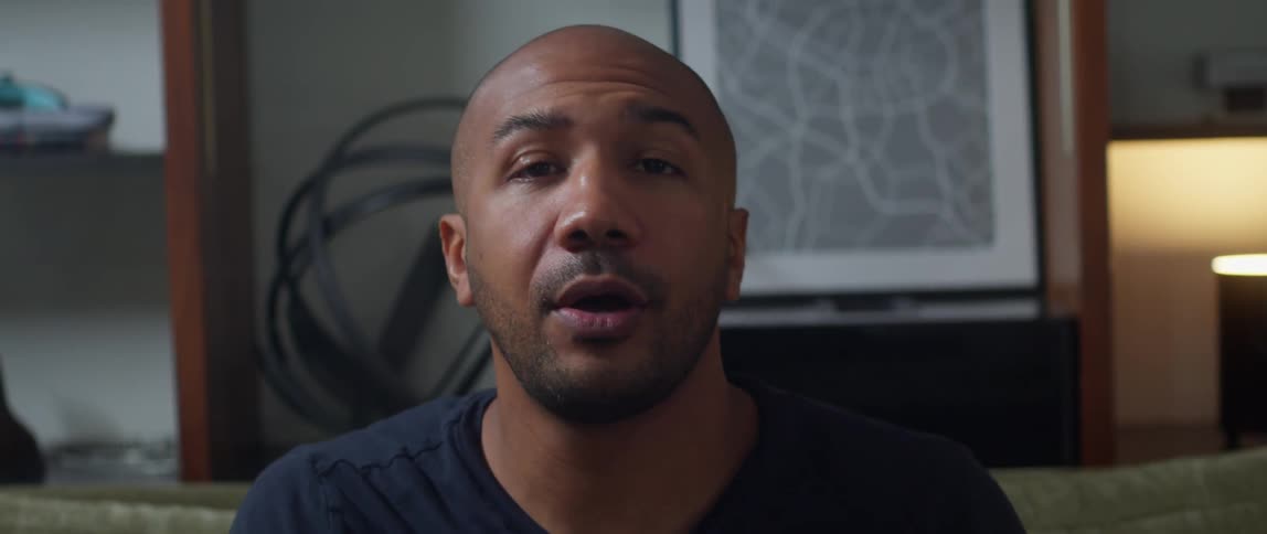 A man with an amazed look on his face takes off a virtual reality headset