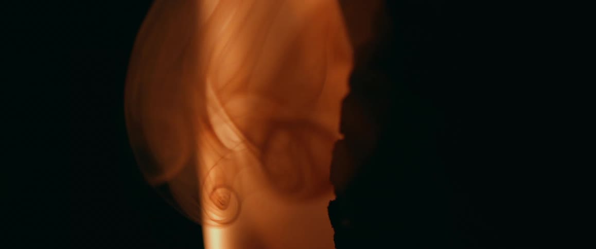 In the darkness flames can been seem burning as smoke wafts upwards