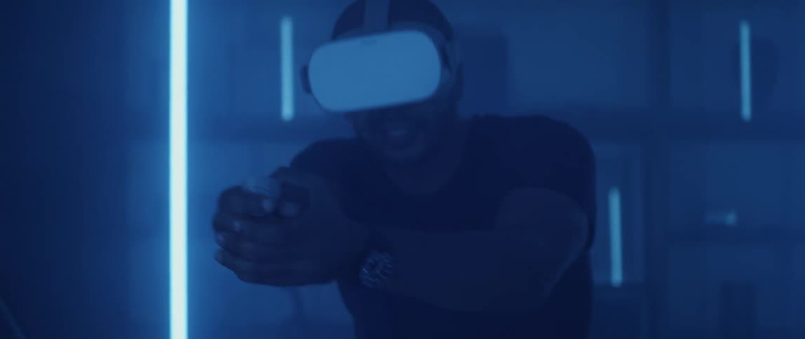 A man playing a shooter game using a virtual reality headset