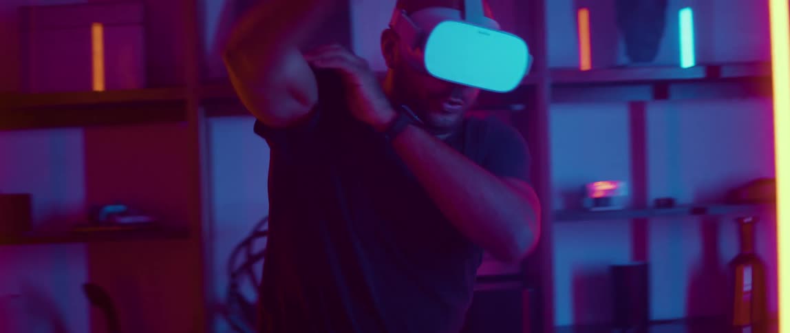 A man swinging his arms around while playing a virtual reality video game