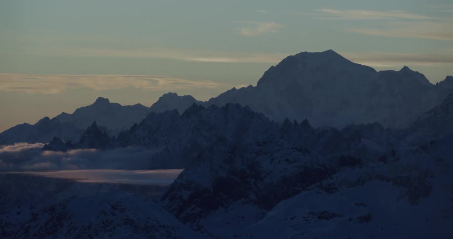 The sun is setting in the horizon of the mountains