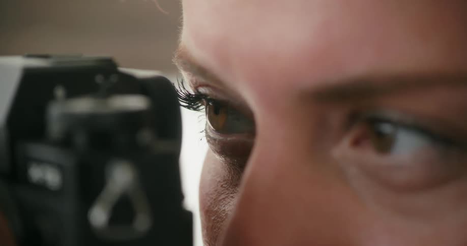 Close up view of a woman taking a photo with a camera is displayed