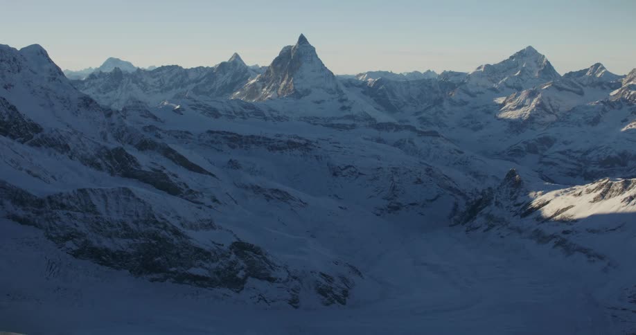Aerial view of snowy mountain range and valley
