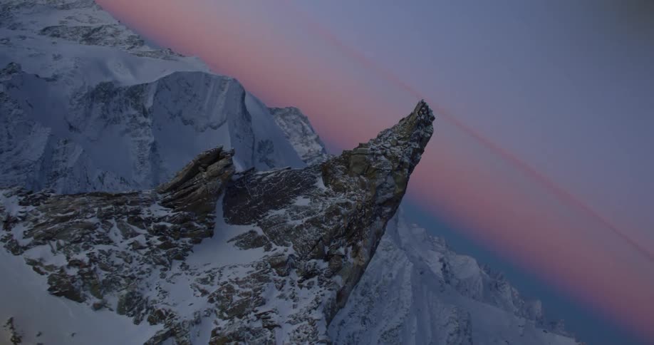 A tall snowy mountain peak in the wilderness