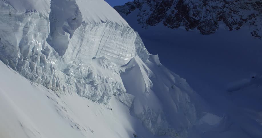 An aerial view of snow covered mountains in the wilderness