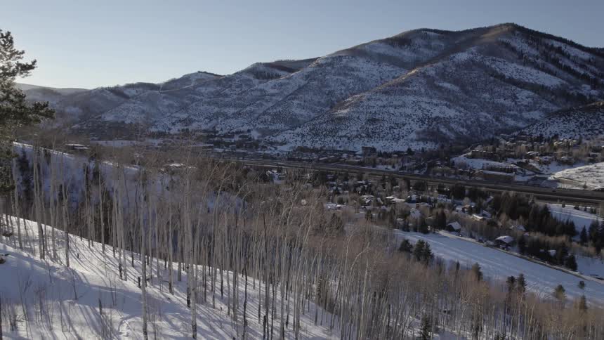 Aerial view of snow covered mountains is displayed
