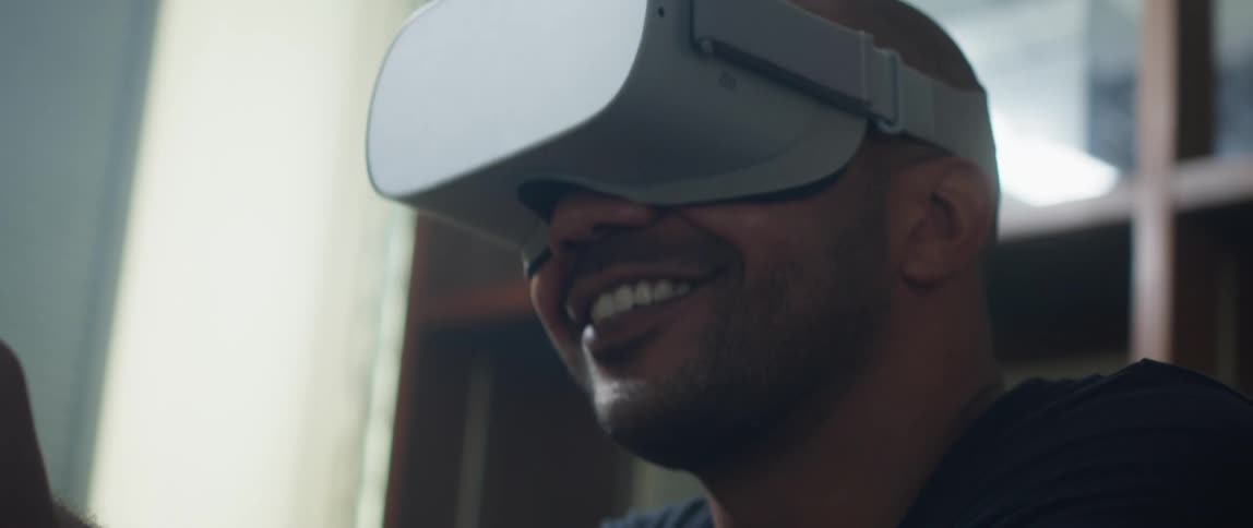 A guy is playing a virtual reality game by himself