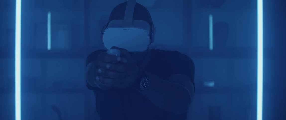 A man playing a shooter game with a virtual reality headset