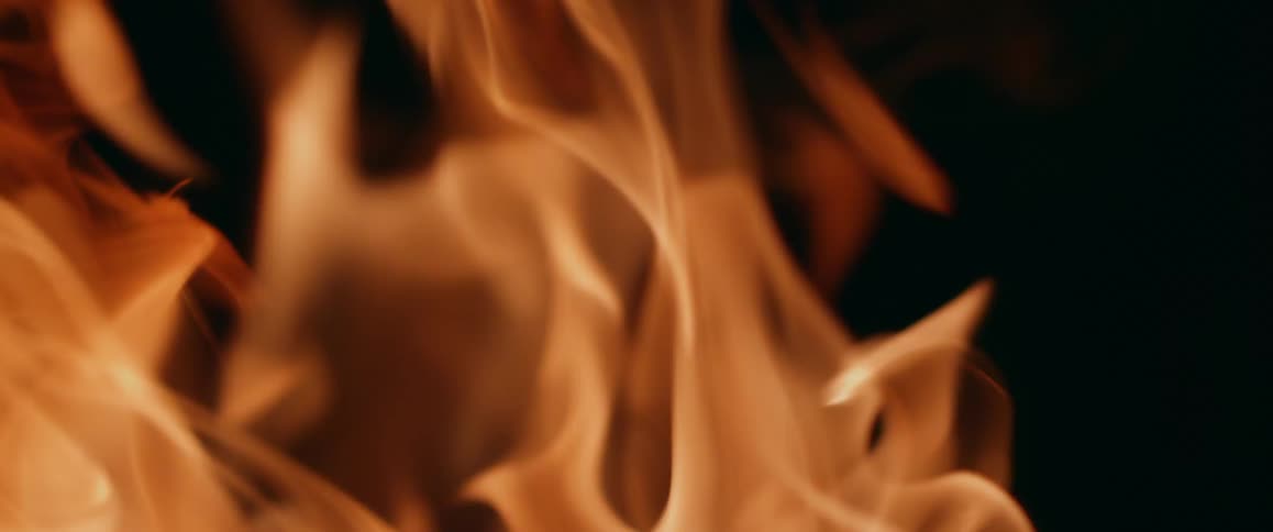 Close up view of a bonfire is displayed at night