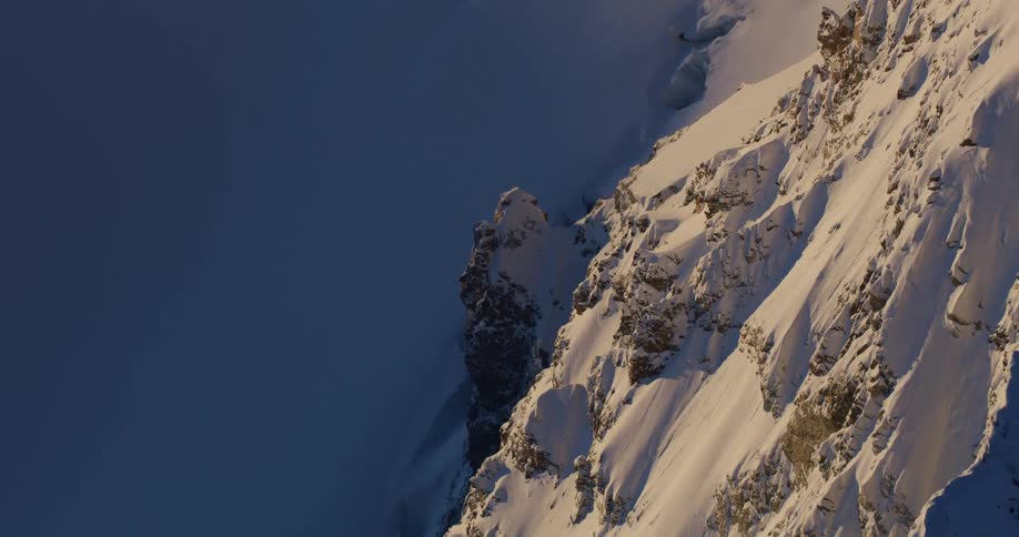 Aerial view of snow covered mountains are displayed