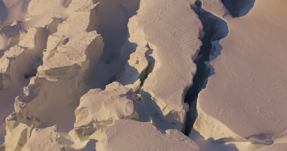 An aerial view of snow covered landscape in the wilderness
