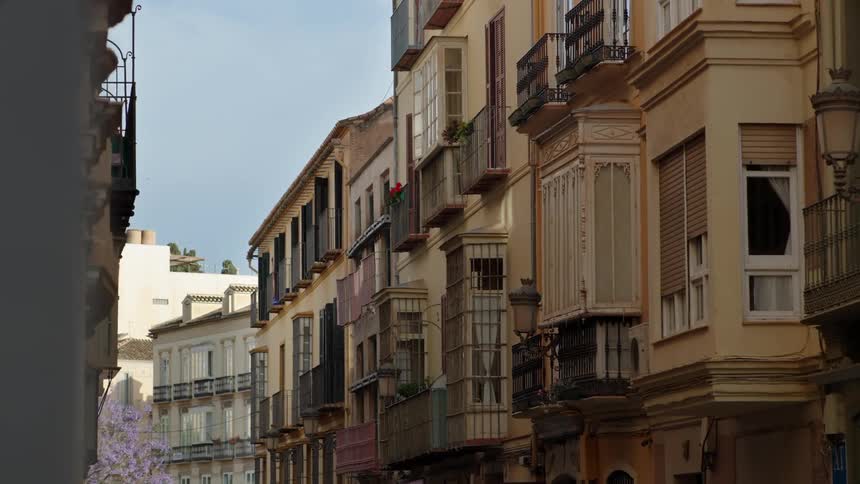 Residential buildings lining a town street in the daytime
