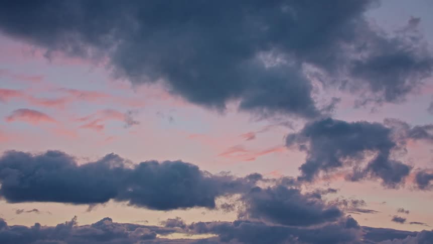 Clouds move through the sky at sunset