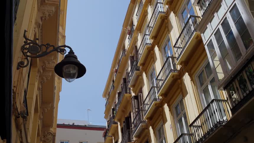 Bright sunlight shines onto the balconies of an apartment complex
