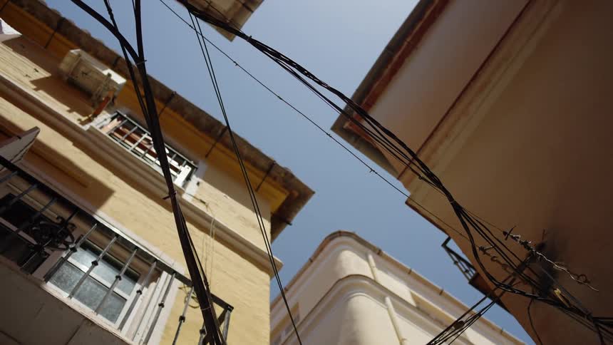 Power lines spanning the gap between two buildings