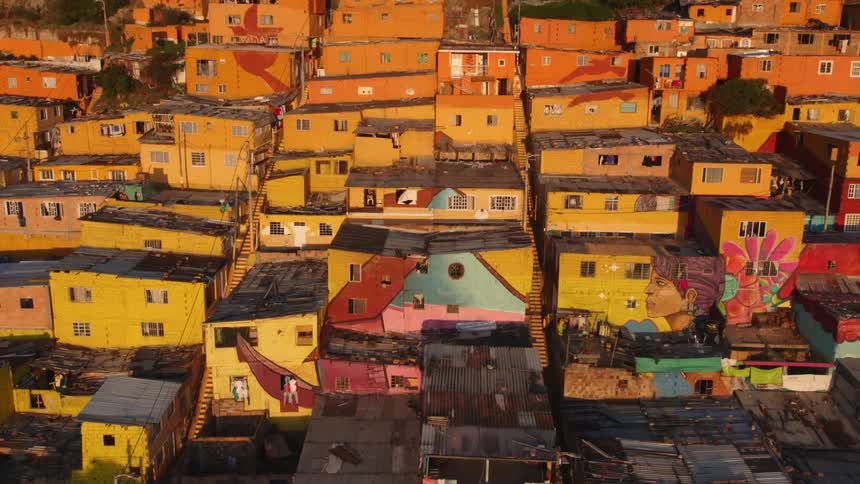 Aerial view of colorful houses on the hills of a mountain at evening