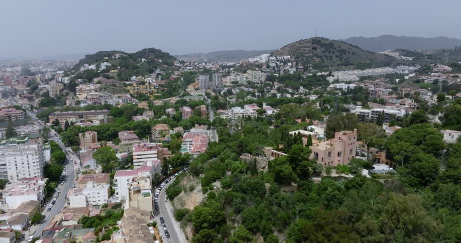 Aerial view of two hills in the middle of a small city at daytime
