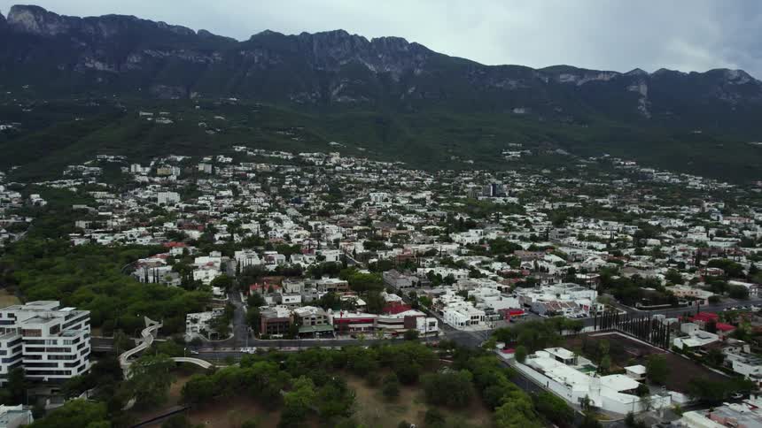 Traffic moves on a road in a town in the mountains