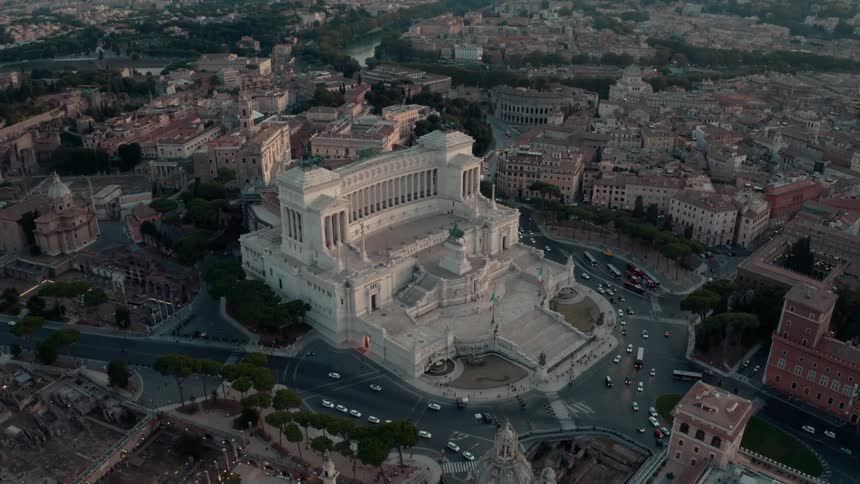 Aerial view of a beautiful classical building in the middle of a small city at evening