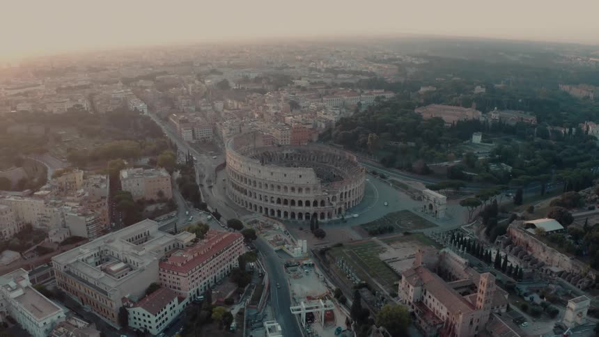 The colosseum in rome under a foggy daytime sky