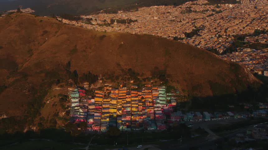 Colorful buildings are on the side of a mountain in a city