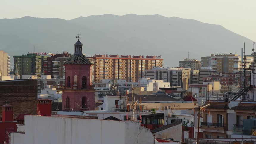 Historical buildings sit alongside more modern apartment buildings in a city
