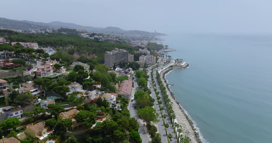 Aerial view of a coastal city next to a beach in front of the ocean